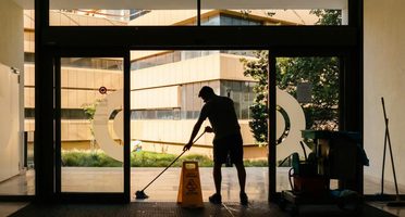 Professional cleaning crew walking through a commercial space with a supervisor