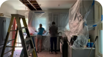 House interior covered in protective plastic during cleanup